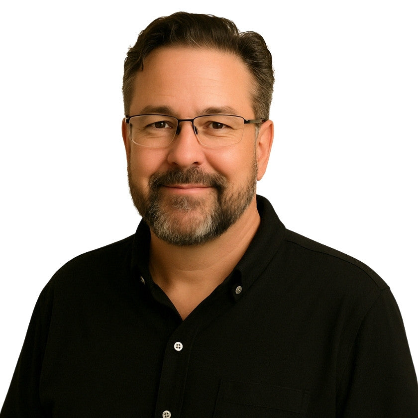Man wearing glasses and a black shirt on a white background