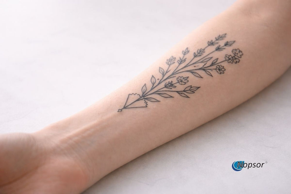 Person with a tattoo on their arm and text about psoriasis and tattoos on a beige background