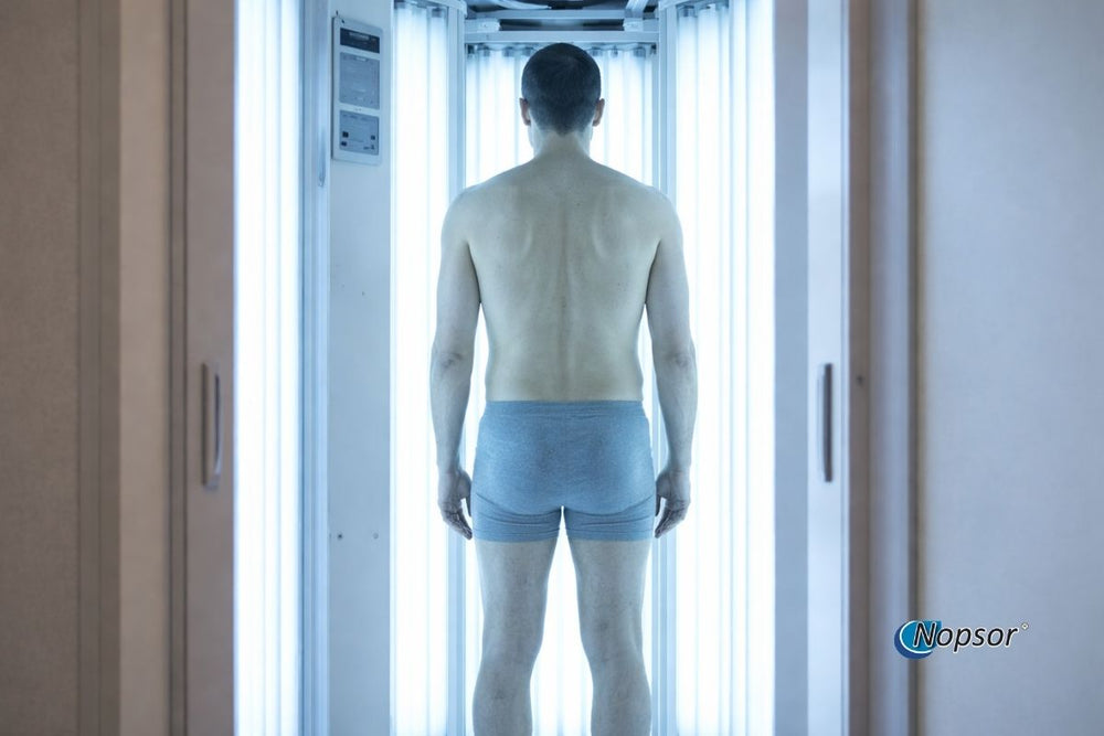 Person standing inside a white chamber with 'Nopsor' branding.